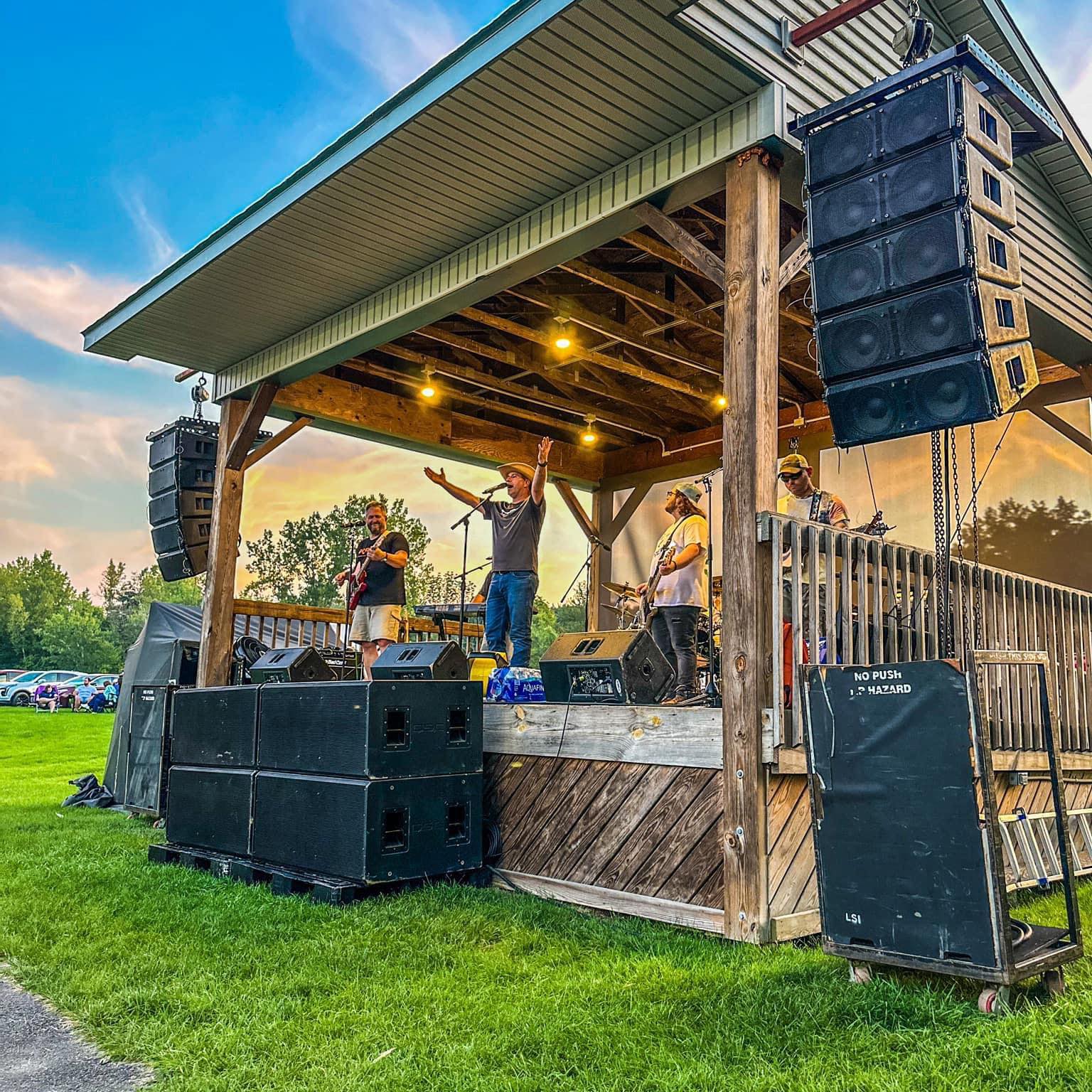 Kyle Bourgault Band performing live on an outdoor stage, country music setting