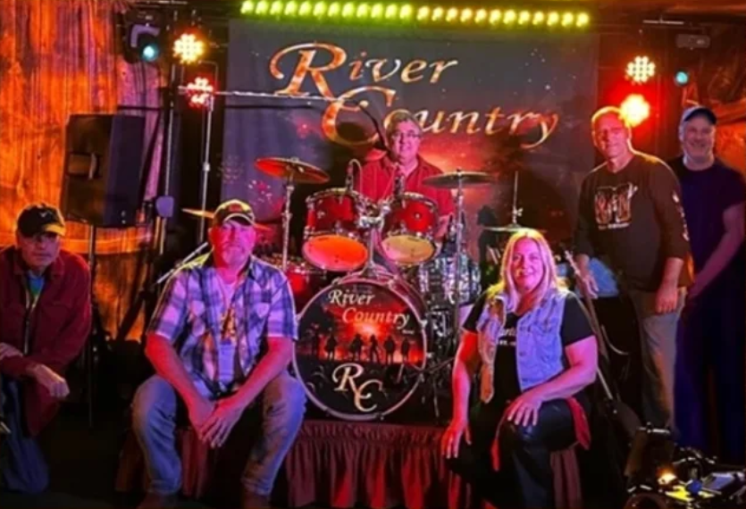 River Country Band performing live, country music setting, outdoor stage
