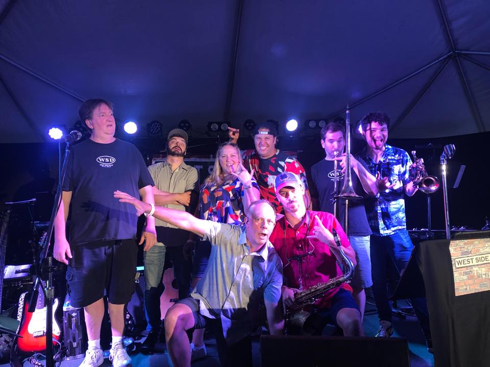 West Side Drive full horn band performing live on stage, high energy dance music