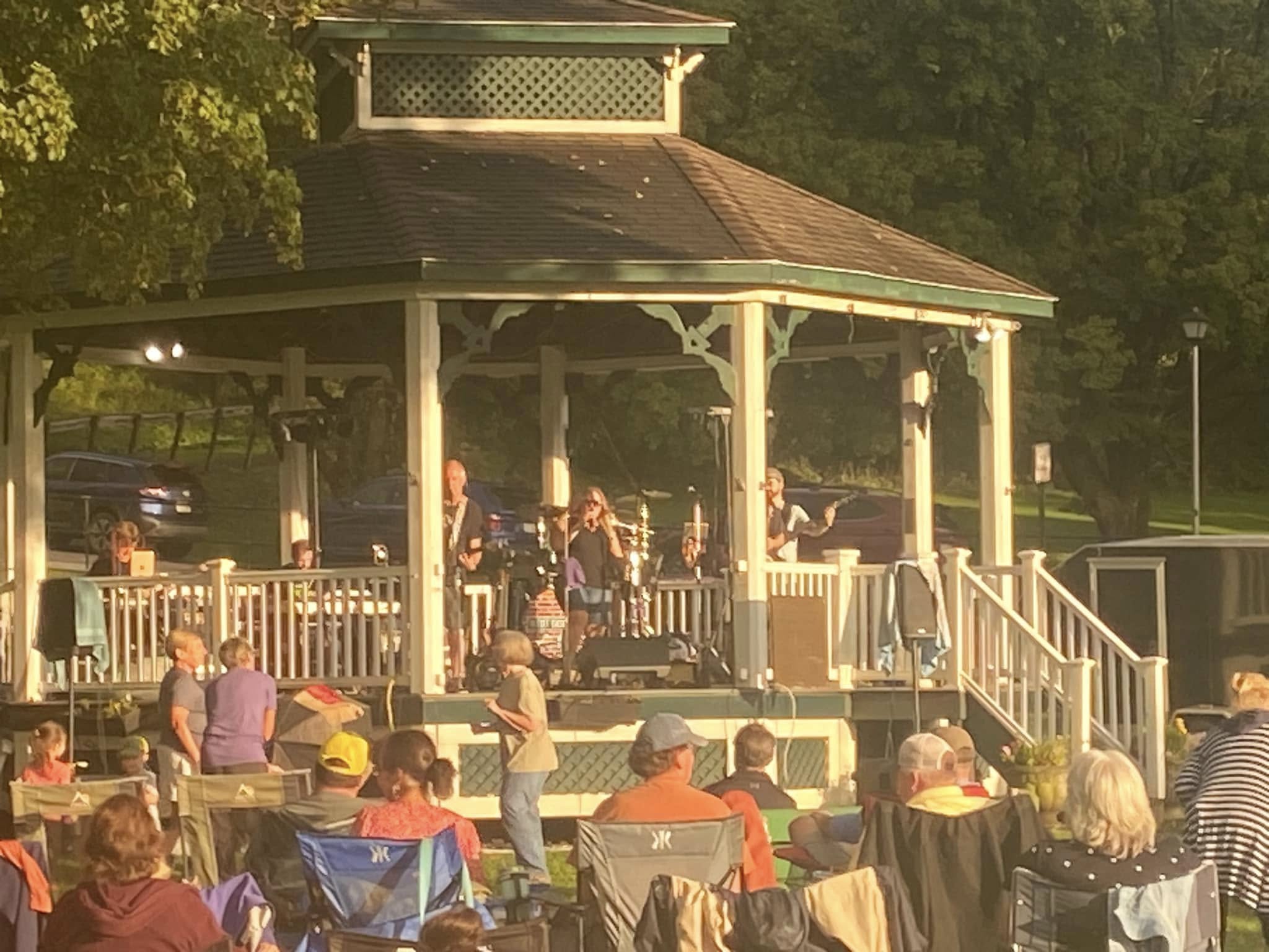 A band on stage during a summer concert.