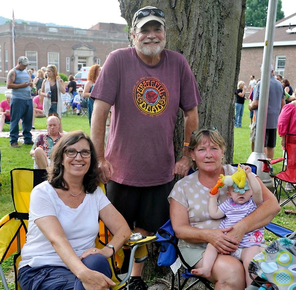 A family settled in their chairs under a shade tree at a Wood Park concert.
